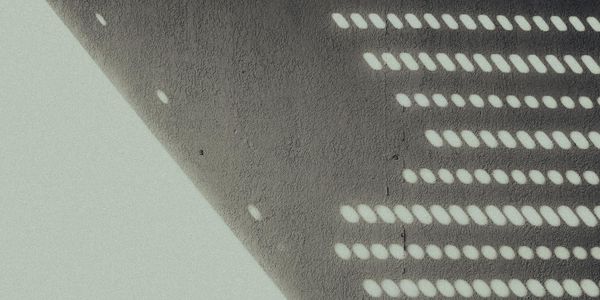 Abstract pattern of light and shadow, creating a sense of rhythm and repetition.